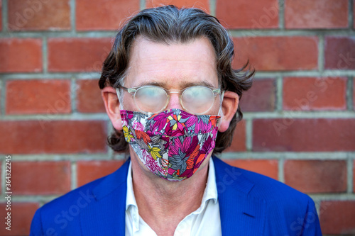 businessman wearing face mask with his glasses fooged up photo