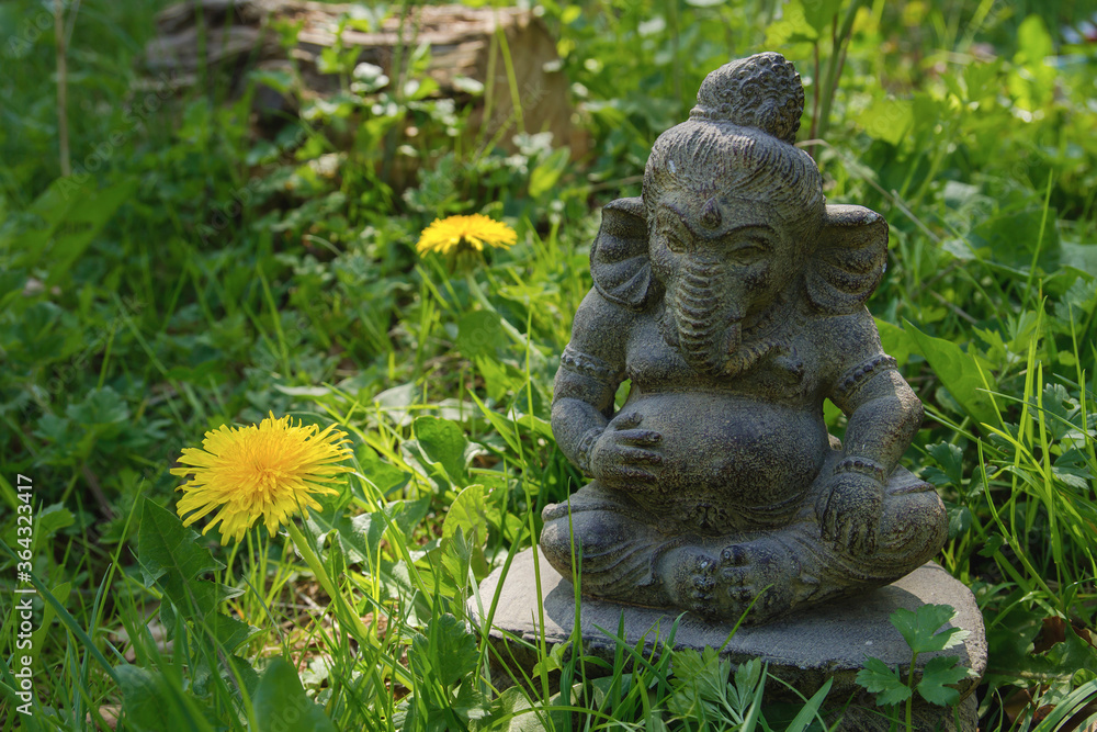 ganesh stone statue on the grass