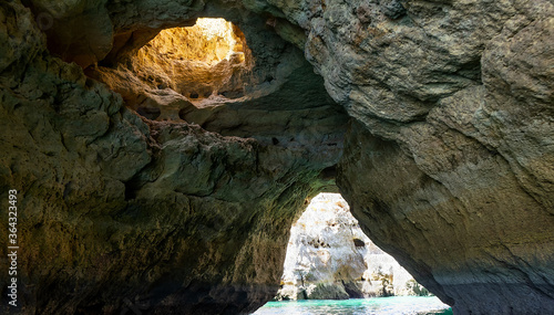 Albufeira, Portugal - July 11, 2020: A group of tourist in a boat visiting the caves of Benagil photo