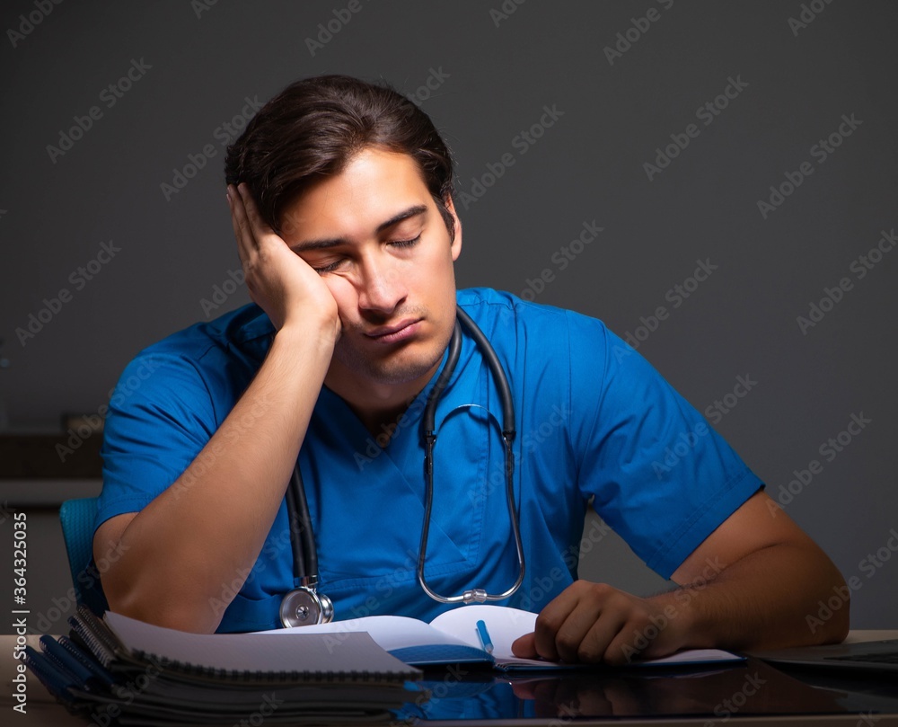 Young handsome doctor working night shift in hospital Young handsome doctor working night shift in hospital