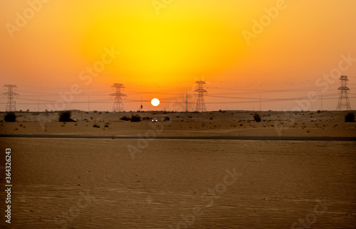 High voltage power lines in the desert during sunset © Four_Lakes