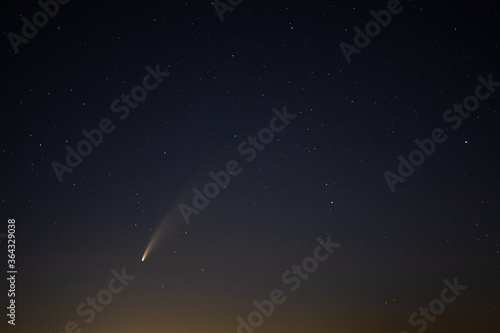 View of the C/2020 F3 (NEOWISE) comet with tail above Europe. Starry night sky. Photo taken on July 12, 2020