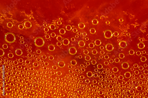 Water drops. Condensate. Macro photo. Orange abstract background made of drops. Beer texture close-up. Raindrops on an orange surface. Orange texture of dew drops on the surface. Drops close up.