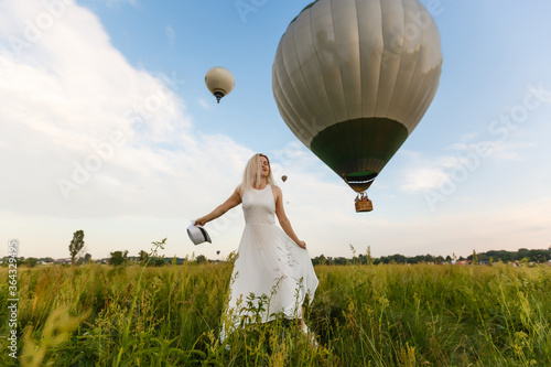 Amazing view with woman and air balloon. Artistic picture. Beauty world. The feeling of complete freedom