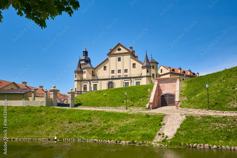 Fototapeta premium Nesvizh castle in summer day with blue sky. Tourism landmark in Belarus, cultural monument