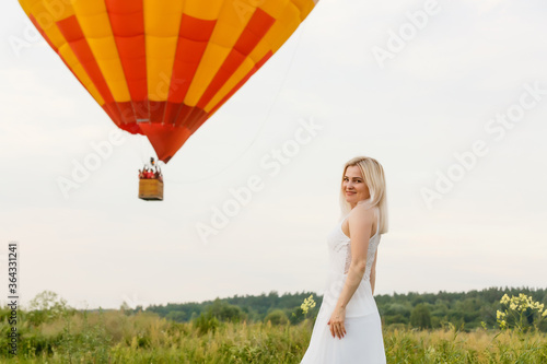 Amazing view with woman and air balloon. Artistic picture. Beauty world. The feeling of complete freedom