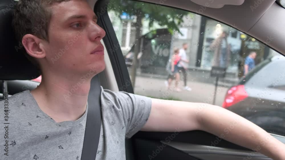 Young attractive male bored in the traffic jam behind the wheel of a car Young attractive male bored in the traffic jam behind the wheel of a car
