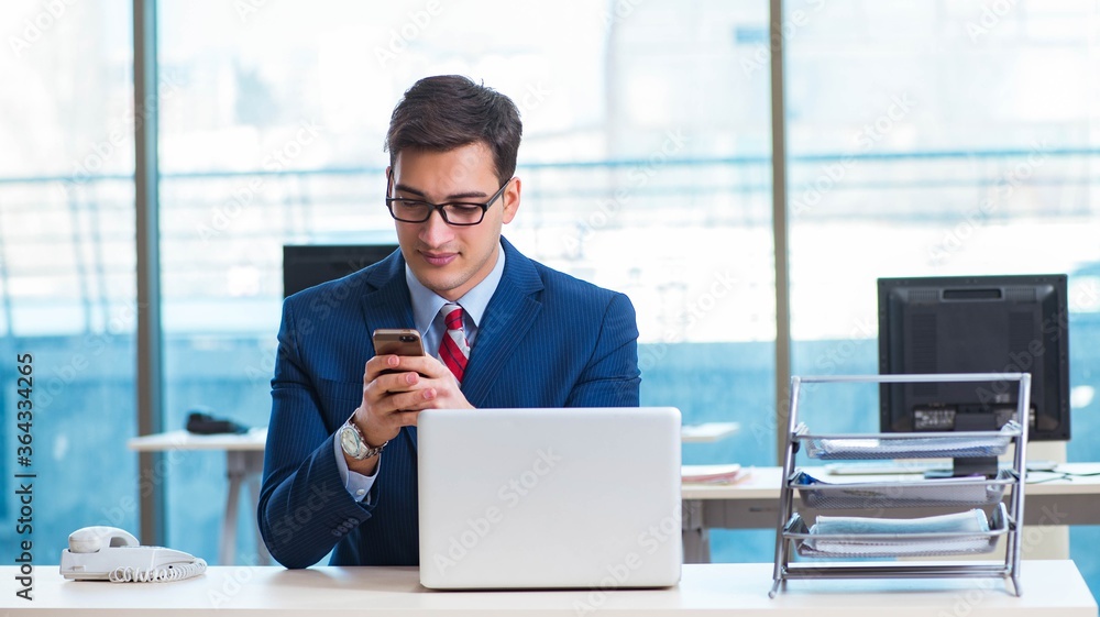 Businessman employee talking on the office phone Businessman employee talking on the office phone