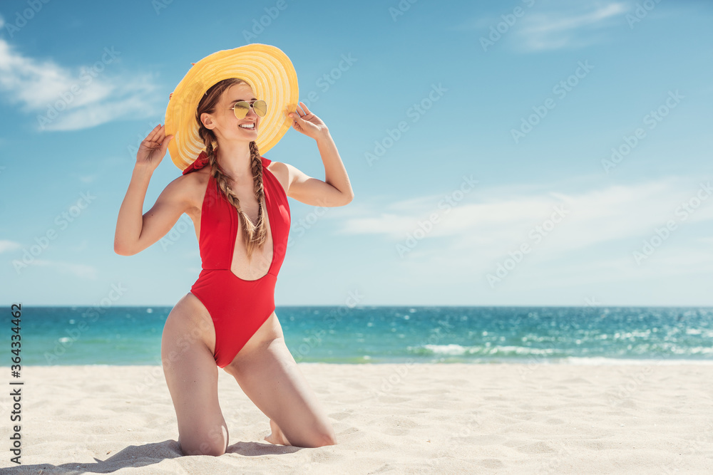 Woman in her beach vacation with ocean in the background Woman in her beach vacation with ocean in the background