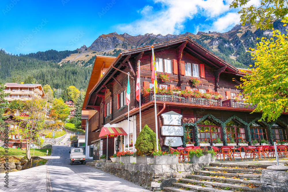 Fantastic autumn view of traditional swiss chalets in Wengen village