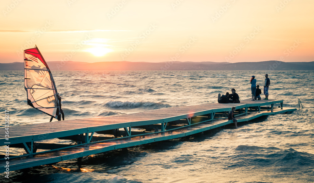 Naklejka premium Sunset scene at lake Balaton with windsurfer