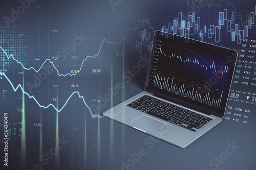 Laptop with creative stock chart and financial analytics.