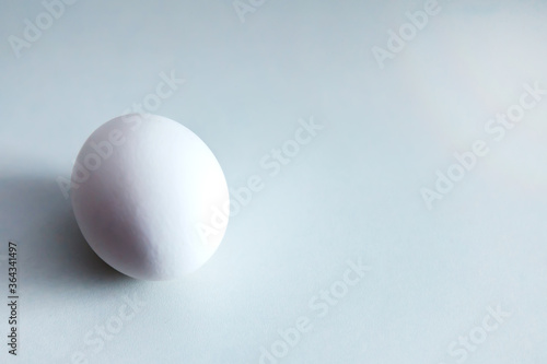 White chicken eggs on white background. Egg on table, natural healthy food. Creative minimalistic background. Concept organic farming and proper nutrition. Place for an inscription or logo