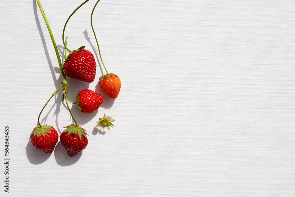 Fotografie Sweet strawberries on light background with copy space.