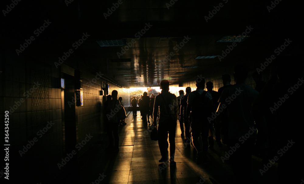 Silhouette of people in the underpass.