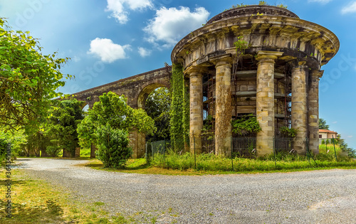 A view of the temple tank of San Concordio and the Nottolini aqueduct in Lucca Italy in summer photo