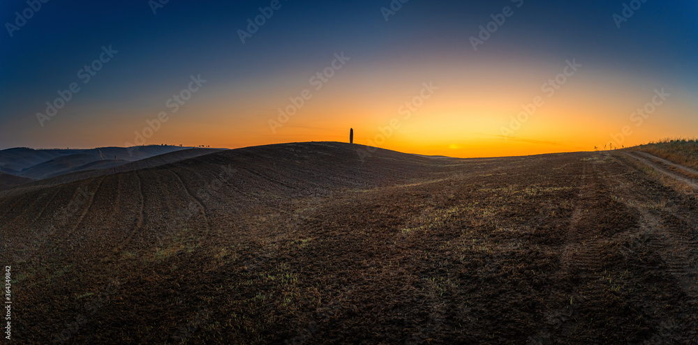 Beautiful wide angle view of sunrise over the Tuscany fields and hills Beautiful wide angle view of sunrise over the Tuscany fields and hills