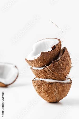 Cracked coconut with pieces on the white background. tropical concept