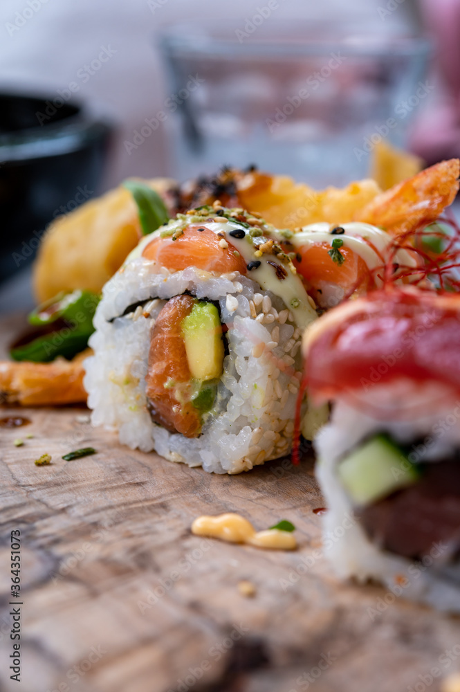 Japanese food, sushi or sashimi made from rice with salmon, avocado, cucumber, red fish caviar, tempura shrimps Japanese food, sushi or sashimi made from rice with salmon, avocado, cucumber, red fish caviar, tempura shrimps