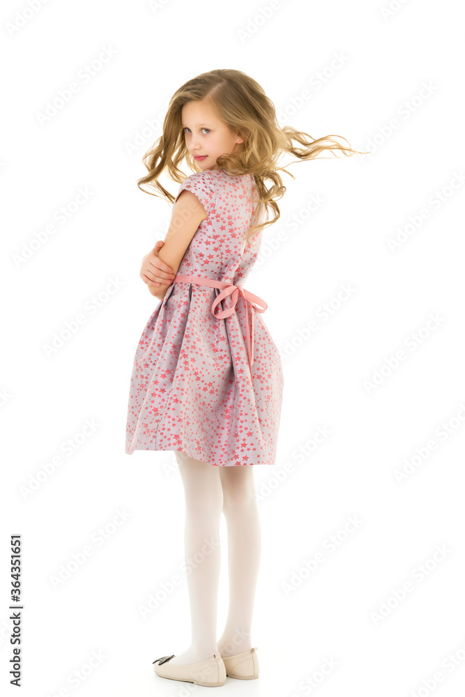Smiling Blonde Girl with Long Hair Standing Holding Hem of her Dress. Smiling Blonde Girl with Long Hair Standing Holding Hem of her Dress.
