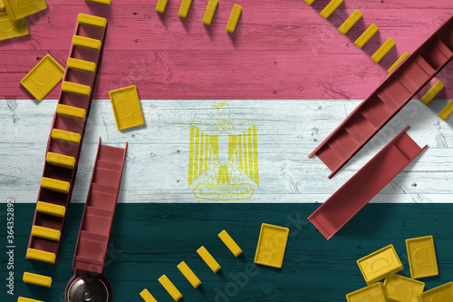 Egypt flag with national background with dominoes on wooden table. Top view. Concept of game.