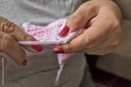 Knitting hands woman close-up. Stitches crafts photo