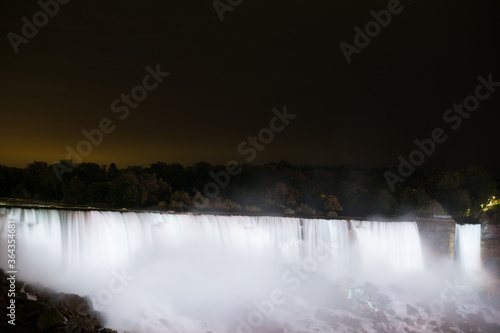 Thunderous Niagara waterfalls in night with colorful lights in Niagara  Ontario  Canada