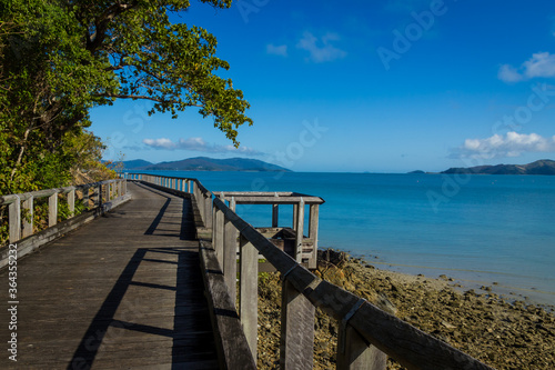 Wooden boardwalk on sunny rocky shores. Daytime  Long Island  Queensland  Australia. 