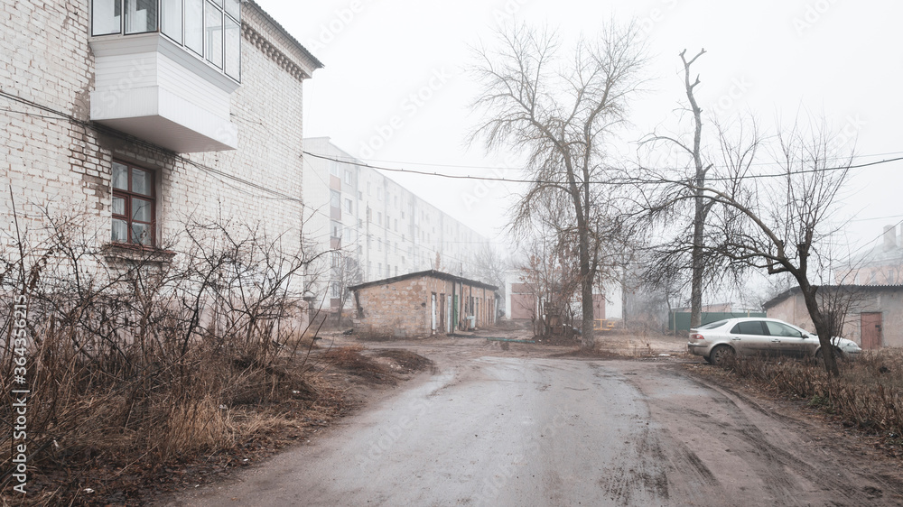 Foggy morning in a provincial Russian city. Barns, houses, car. Foggy morning in a provincial Russian city. Barns, houses, car.