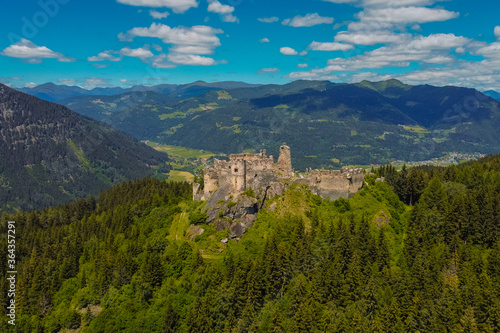 Aerial drone panorama of Steinschloss castle ruins rising above the mura valley in styria, Austria. Medieval ruins in Austria on a sunny day.