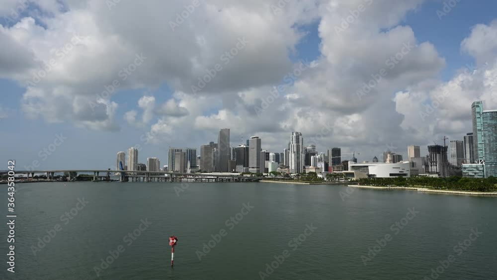 Timelapse of City of Miami skyline and Intracoastal Waterway on sunny summer day with passing light clouds 4K. Timelapse of City of Miami skyline and Intracoastal Waterway on sunny summer day with passing light clouds 4K.