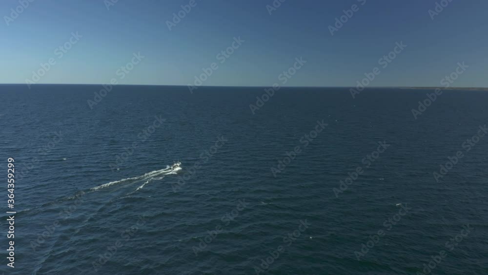 Motor boat on open sea ocean, follow aerial view Motor boat on open sea ocean, follow aerial view