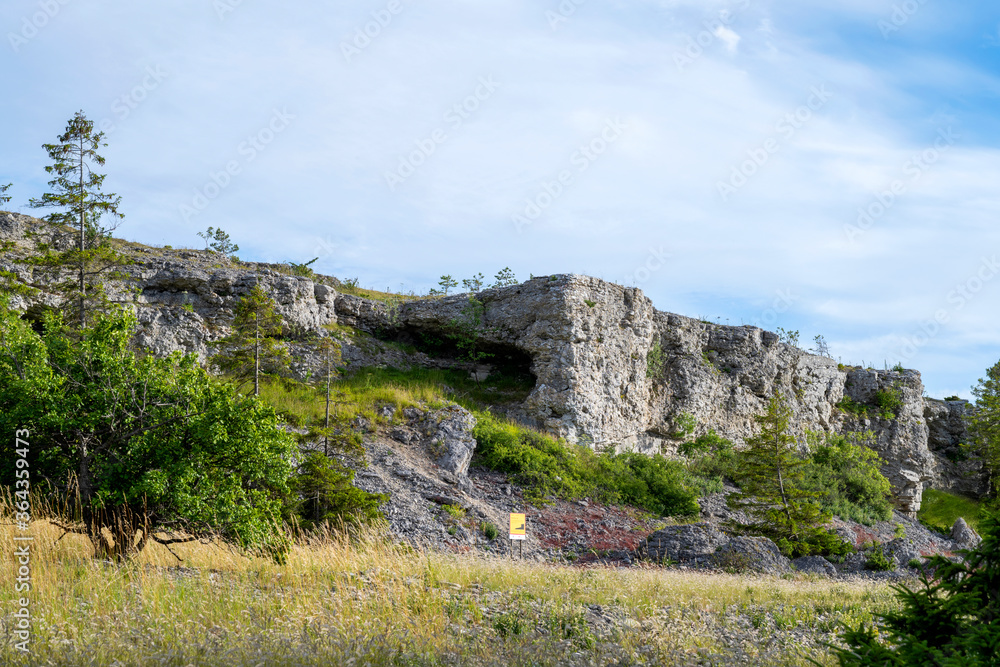 Limestone cliff face under blue cloudy sky