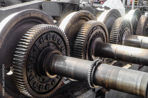 Driving wheelset with gears in a repair depot. Cogwheels of traction gears of traction rolling stock.