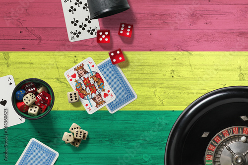 Bolivia casino theme. Aces in poker game, cards and chips on red table with national wooden flag background. Gambling and betting. photo