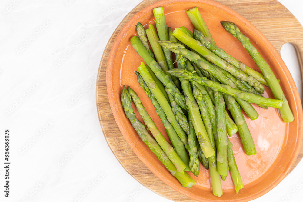 Cooked asparagus on the wooden board Cooked asparagus on the wooden board