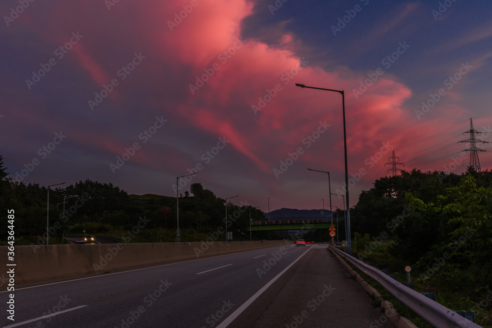  Large pink clouds over highway