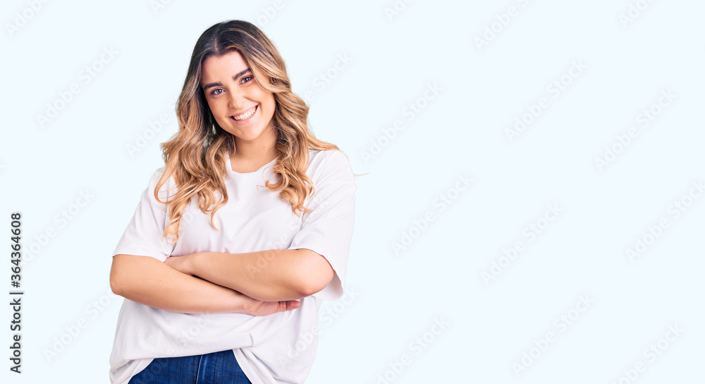Young caucasian woman wearing casual clothes happy face smiling with crossed arms looking at the camera. positive person. Young caucasian woman wearing casual clothes happy face smiling with crossed arms looking at the camera. positive person.