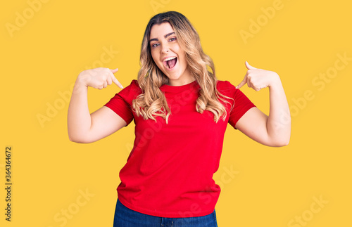 Young caucasian woman wearing casual clothes looking confident with smile on face, pointing oneself with fingers proud and happy.