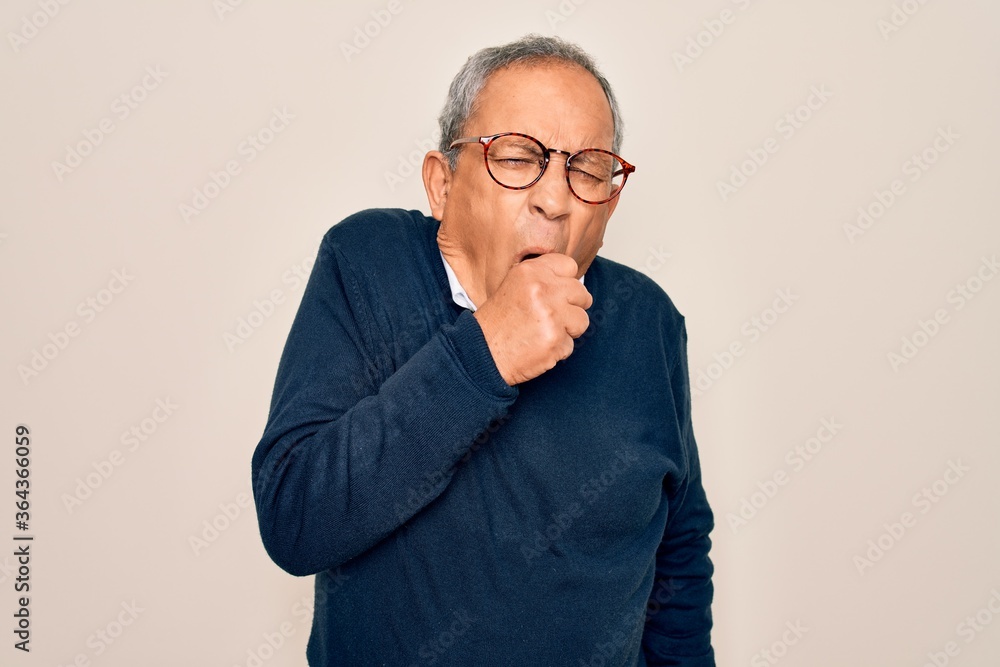 Senior handsome grey-haired man wearing sweater and glasses over isolated white background feeling unwell and coughing as symptom for cold or bronchitis. Health care concept. Senior handsome grey-haired man wearing sweater and glasses over isolated white background feeling unwell and coughing as symptom for cold or bronchitis. Health care concept.