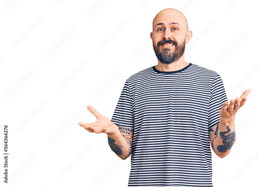Young handsome man wearing casual clothes clueless and confused expression with arms and hands raised. doubt concept. Young handsome man wearing casual clothes clueless and confused expression with arms and hands raised. doubt concept.