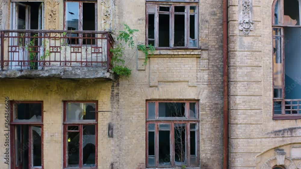 Abandoned old commercial apartment building in the Art Nouveau style (Modern Style) with a broken windows. Deserted early 20th century house. Aerial side view Abandoned old commercial apartment building in the Art Nouveau style (Modern Style) with a broken windows. Deserted early 20th century house. Aerial side view