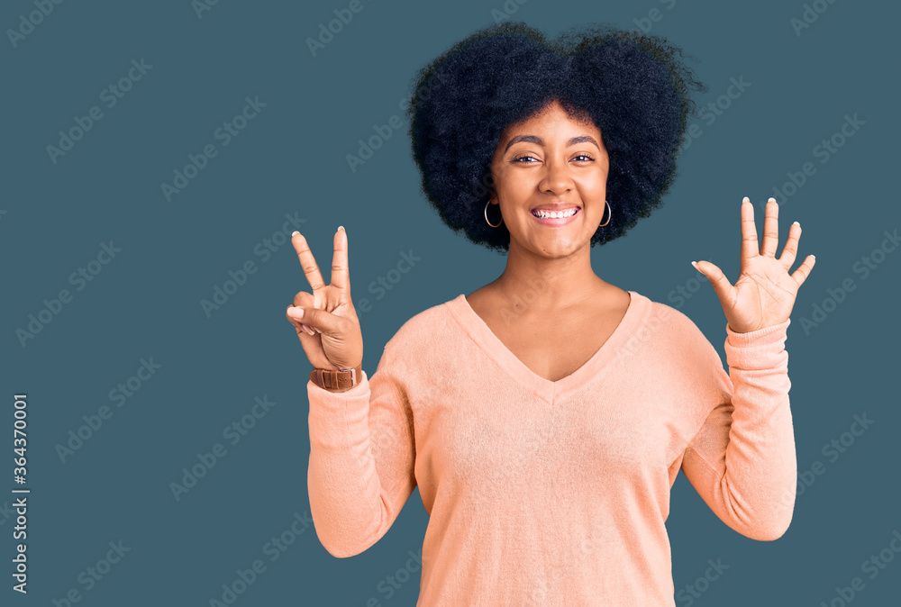 Young african american girl wearing casual clothes showing and pointing up with fingers number seven while smiling confident and happy. Young african american girl wearing casual clothes showing and pointing up with fingers number seven while smiling confident and happy.