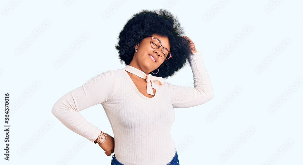 Young african american girl wearing casual clothes and glasses stretching back, tired and relaxed, sleepy and yawning for early morning Young african american girl wearing casual clothes and glasses stretching back, tired and relaxed, sleepy and yawning for early morning