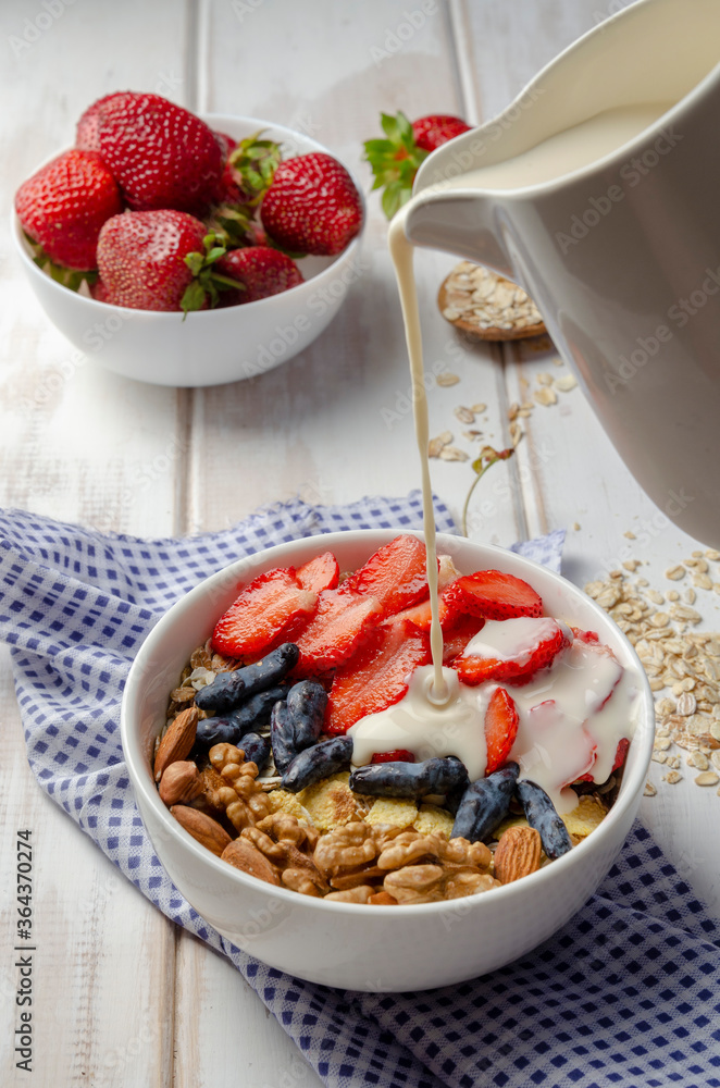 Homemade muesli bowl with strawberry, banana, nuts Homemade muesli bowl with strawberry, banana, nuts
