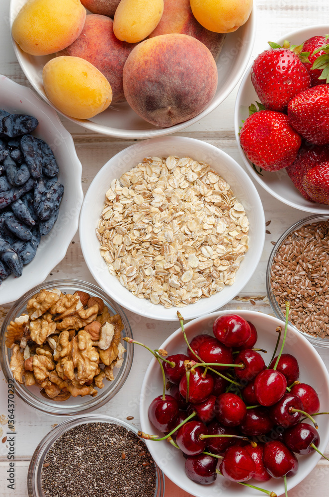 ingredients for making musdi or smoothie. Nuts, seeds, berries and fruits.