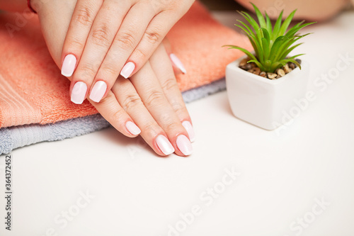 Woman close up demonstrates a fresh manicure