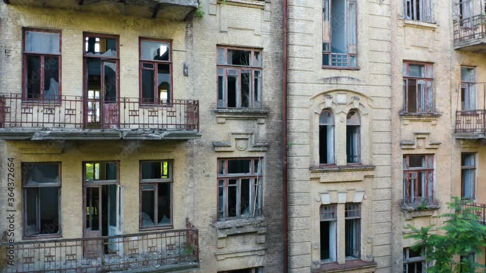Abandoned old commercial apartment building in the Art Nouveau style (Modern Style) with a broken windows. Deserted early 20th century house. Aerial side view Abandoned old commercial apartment building in the Art Nouveau style (Modern Style) with a broken windows. Deserted early 20th century house. Aerial side view
