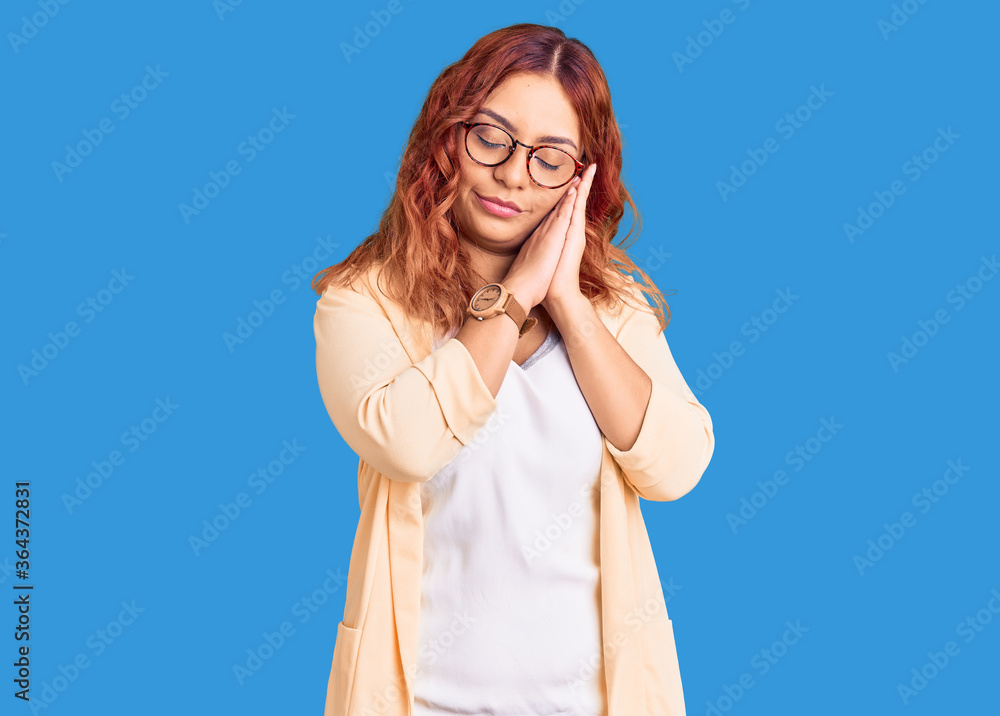 Young latin woman wearing business clothes sleeping tired dreaming and posing with hands together while smiling with closed eyes. Young latin woman wearing business clothes sleeping tired dreaming and posing with hands together while smiling with closed eyes.
