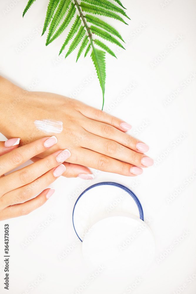 Woman close up applies moisturizer for hand skin care